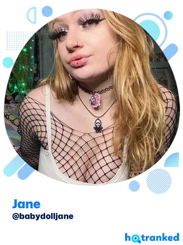 Jane wearing fishnet top and layered necklaces indoors