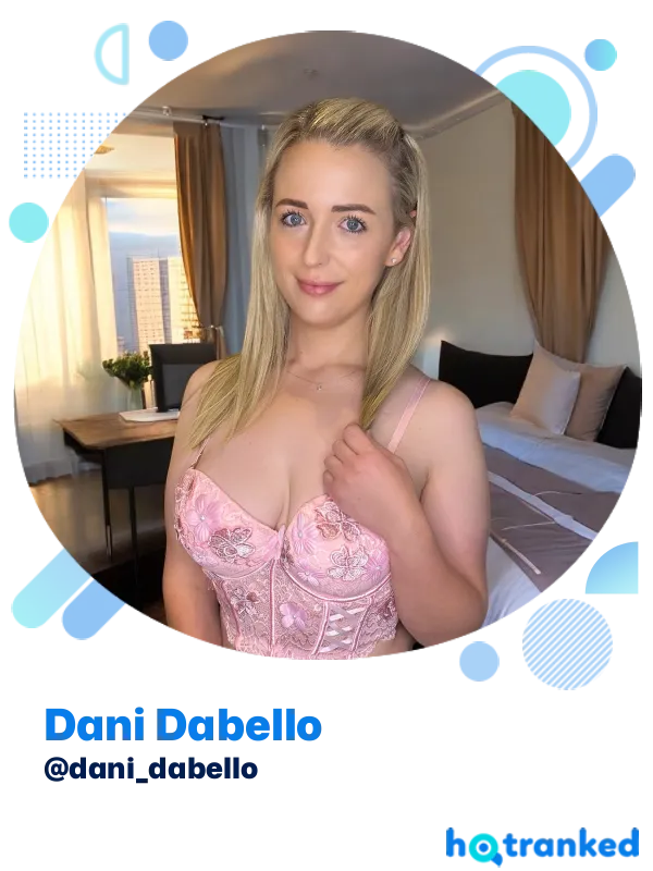 smiling Dani Dabello in pink corset indoors