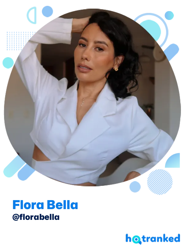 Flora Bella posing confidently in a white cropped jacket