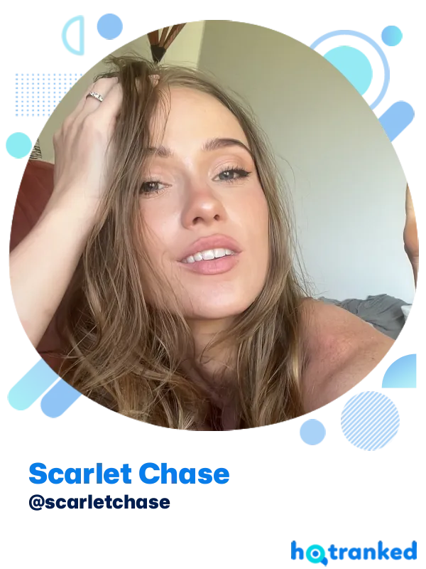 relaxed Scarlet Chase with hand in hair indoors