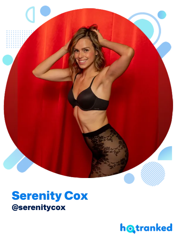 Serenity Cox posing confidently in black lingerie by red curtain